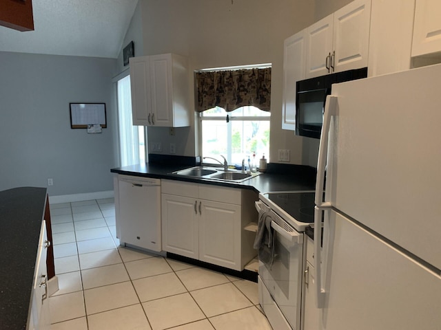 kitchen with white appliances, sink, light tile patterned floors, white cabinetry, and lofted ceiling