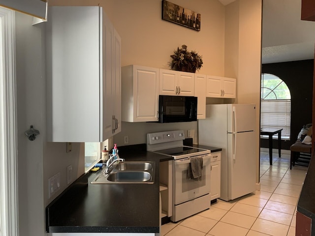 kitchen featuring white cabinets, white appliances, sink, and light tile patterned floors