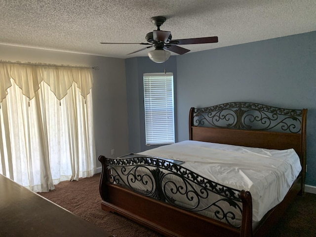 carpeted bedroom featuring ceiling fan and a textured ceiling