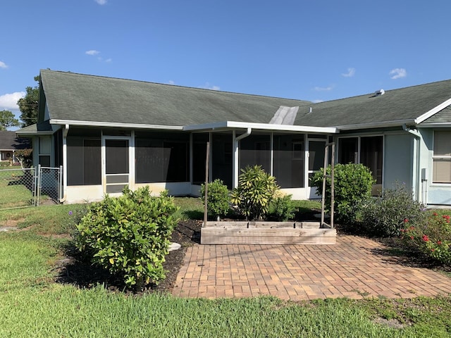 back of property with a patio area and a sunroom