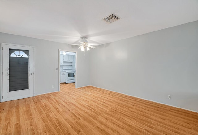 unfurnished living room featuring ceiling fan and light hardwood / wood-style flooring