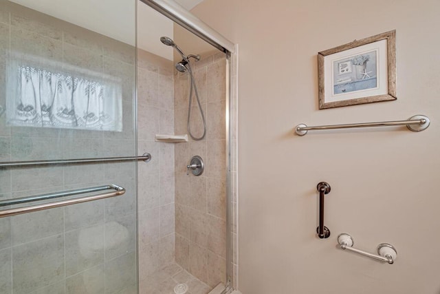 bathroom with a shower with shower door