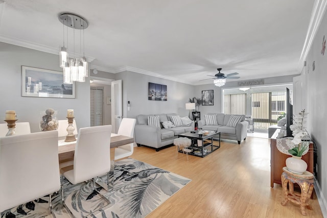 living room with ceiling fan, crown molding, and light hardwood / wood-style flooring