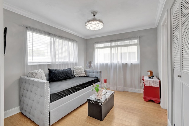 bedroom with light hardwood / wood-style flooring and ornamental molding