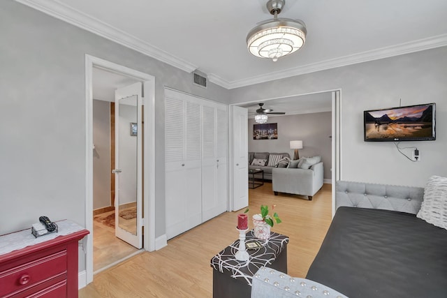 living room with ceiling fan, light hardwood / wood-style floors, and ornamental molding