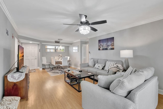 living room with ceiling fan, light hardwood / wood-style flooring, and ornamental molding