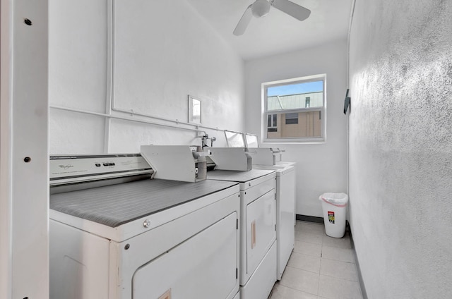 clothes washing area featuring ceiling fan, washing machine and dryer, and light tile patterned floors