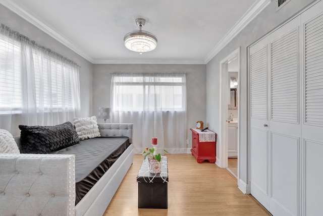 living room with sink, wood-type flooring, and ornamental molding