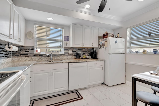 kitchen featuring white cabinets, decorative backsplash, white appliances, and sink