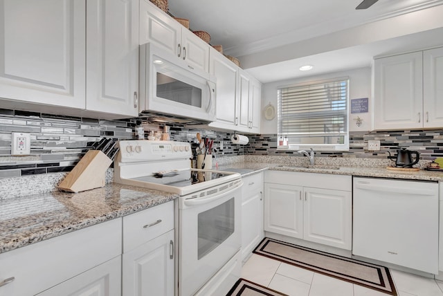 kitchen featuring decorative backsplash, white cabinetry, white appliances, and sink