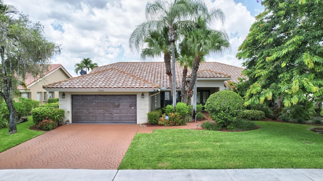 view of front of property featuring a garage and a front lawn