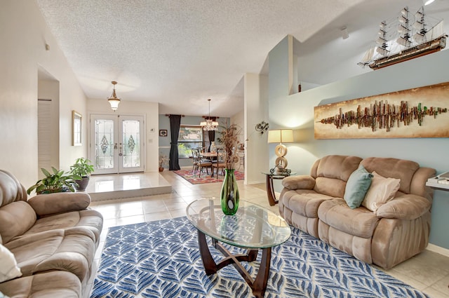 living room with french doors, a textured ceiling, an inviting chandelier, and light tile patterned flooring