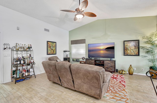 living room with light hardwood / wood-style flooring, ceiling fan, and lofted ceiling