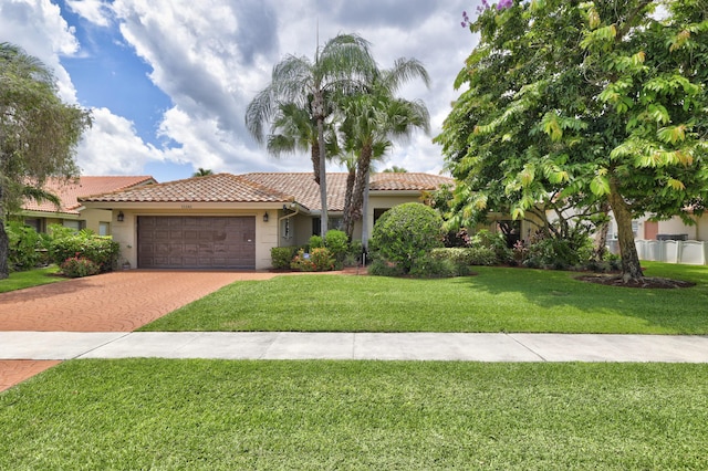 view of front of house with a front yard and a garage