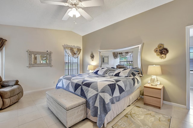 bedroom with ceiling fan, light tile patterned floors, and lofted ceiling