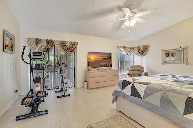 bedroom featuring ceiling fan, light tile patterned flooring, a textured ceiling, and access to outside