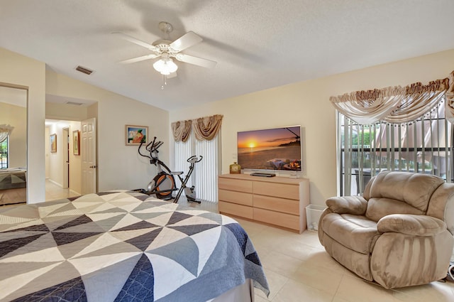 bedroom featuring light tile patterned floors, a textured ceiling, vaulted ceiling, and ceiling fan