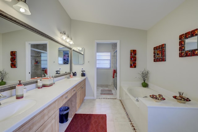 bathroom featuring tile patterned floors, vanity, lofted ceiling, and independent shower and bath