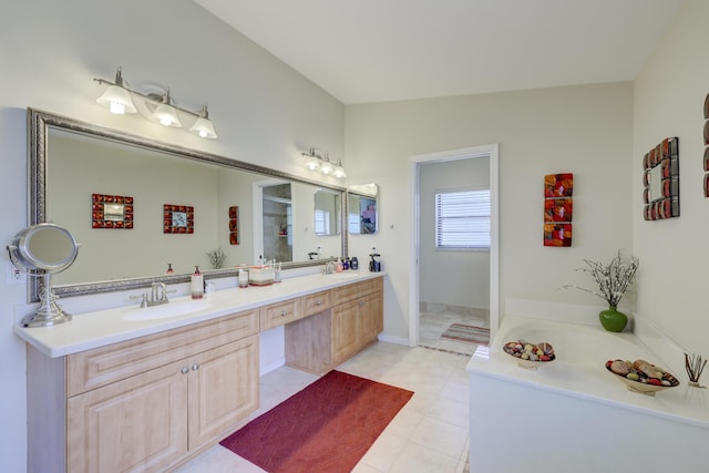 bathroom featuring tile patterned floors, vanity, a tub, and vaulted ceiling