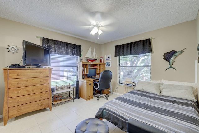 bedroom with ceiling fan and a textured ceiling