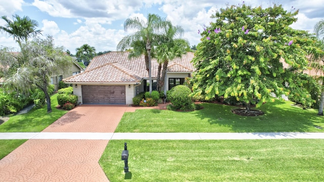 mediterranean / spanish-style house with a front lawn and a garage