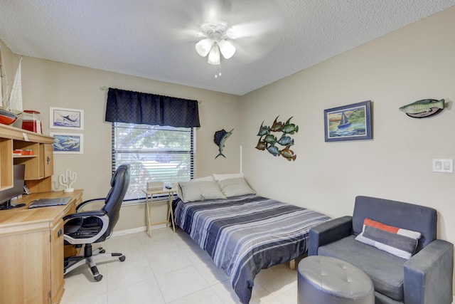 bedroom with ceiling fan and a textured ceiling