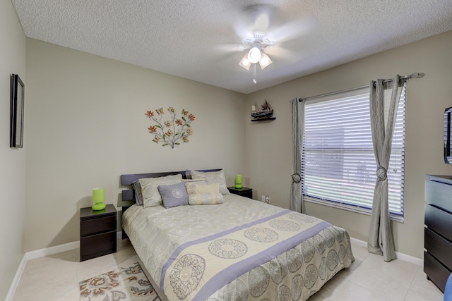 tiled bedroom featuring ceiling fan and a textured ceiling