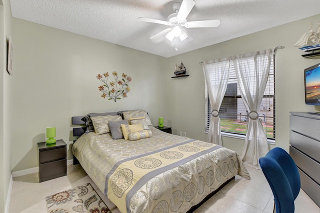 tiled bedroom featuring ceiling fan and a textured ceiling