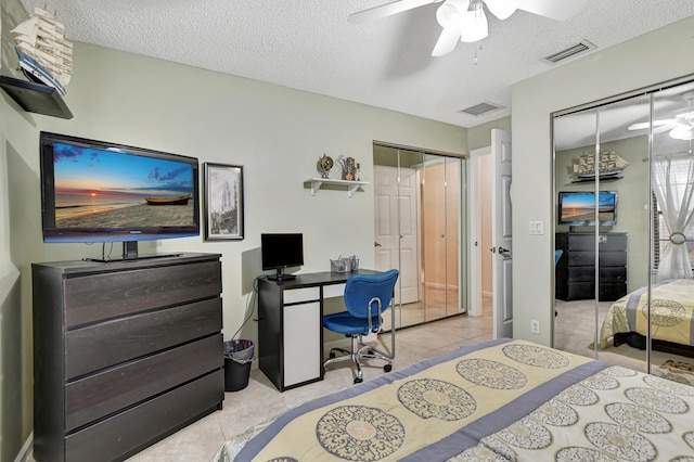 bedroom with light tile patterned floors, a textured ceiling, and ceiling fan