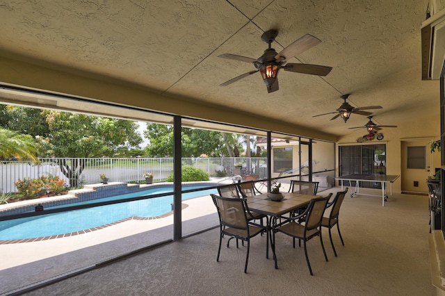 sunroom featuring ceiling fan