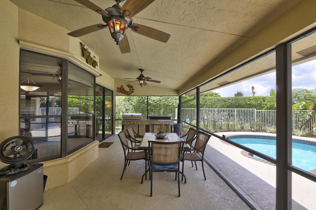 sunroom featuring ceiling fan and lofted ceiling