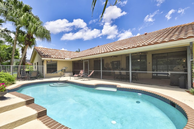 view of pool with ceiling fan, a patio area, and a sunroom