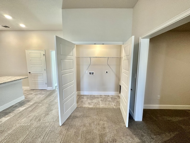 laundry room with hookup for a washing machine, light colored carpet, and electric dryer hookup