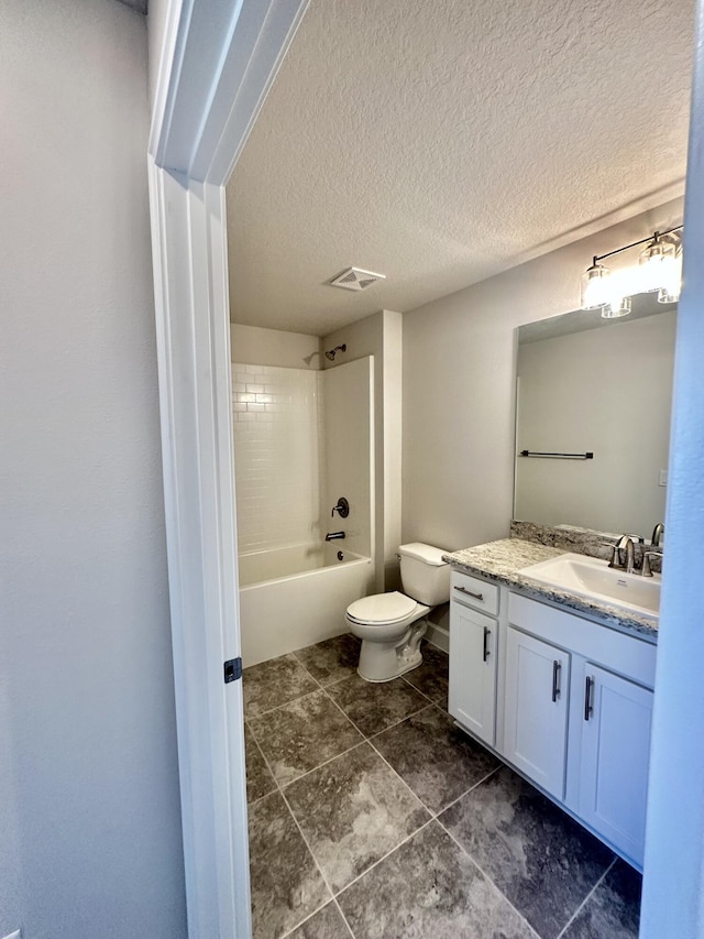 full bathroom with vanity, a textured ceiling, tiled shower / bath combo, and toilet