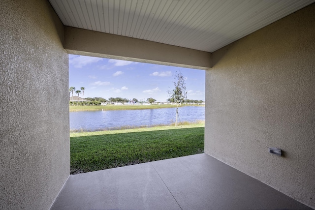 view of patio with a water view