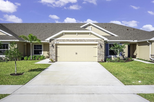 view of front of home featuring a front yard and a garage