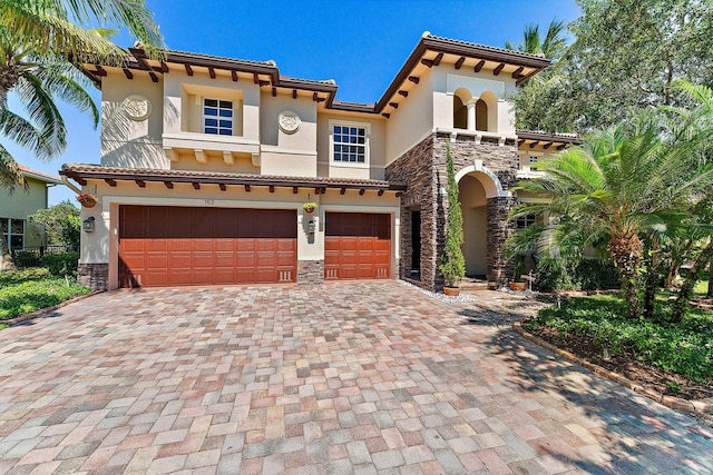 mediterranean / spanish home featuring a garage