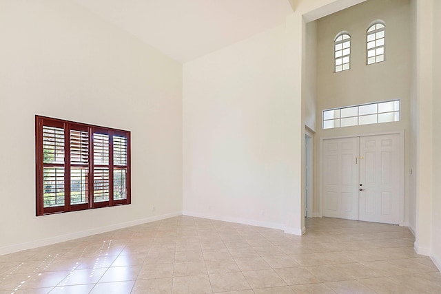 tiled foyer entrance featuring plenty of natural light and a high ceiling