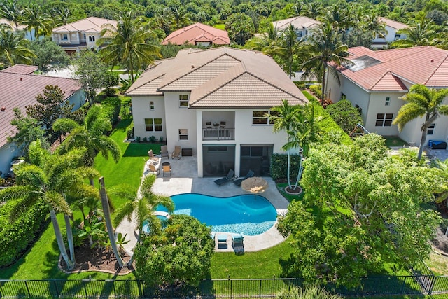 exterior space featuring a tile roof, a yard, stucco siding, a patio area, and a fenced backyard