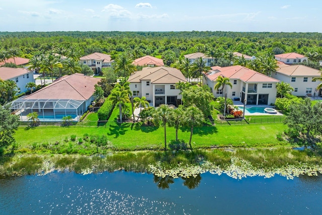 bird's eye view with a water view, a wooded view, and a residential view