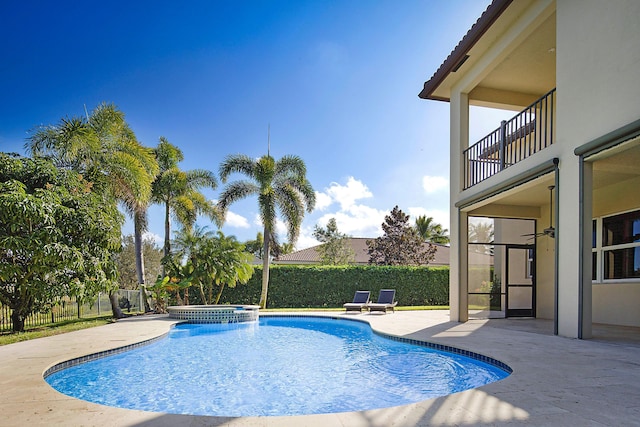 view of pool with a patio, ceiling fan, and an in ground hot tub