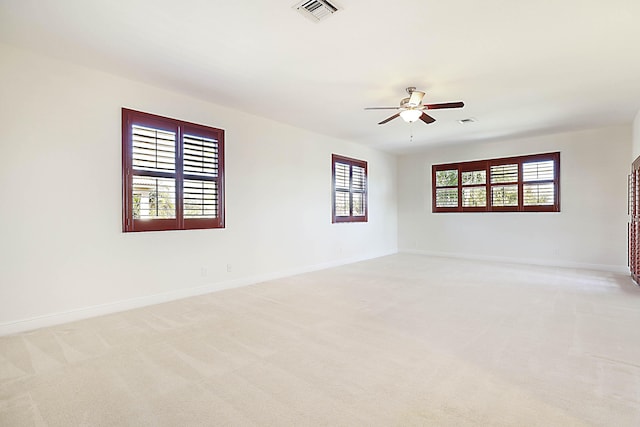 carpeted spare room featuring ceiling fan