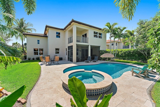 view of pool with an in ground hot tub and a patio