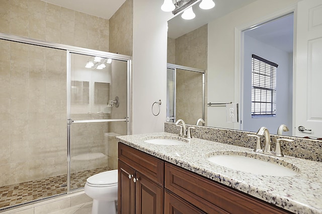 bathroom featuring an enclosed shower, vanity, tile patterned flooring, and toilet