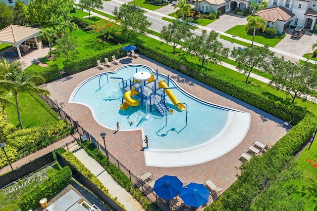 view of swimming pool featuring a playground