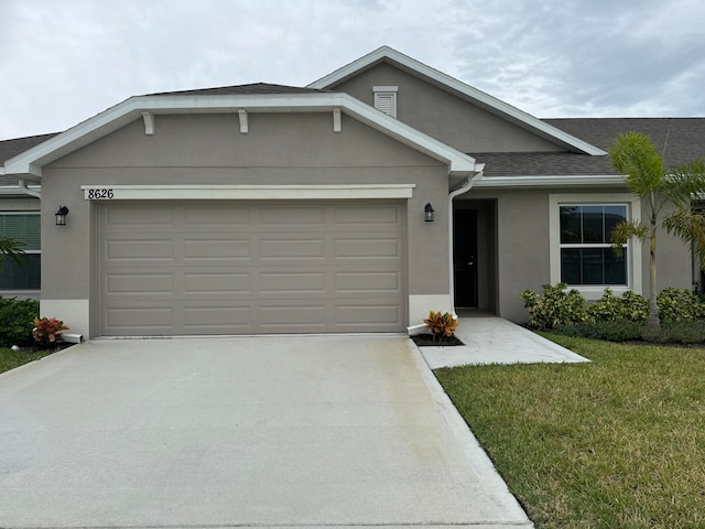 single story home featuring a front yard and a garage