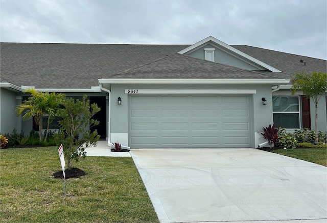 ranch-style house featuring a front yard and a garage