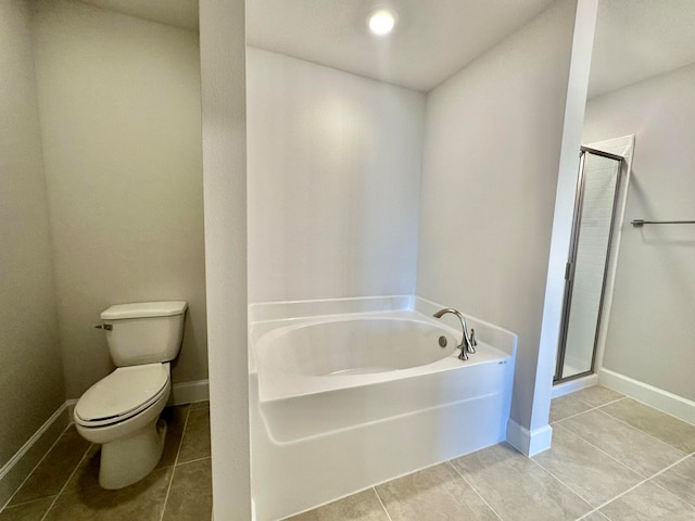 bathroom featuring plus walk in shower, tile patterned floors, and toilet