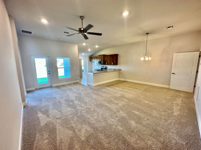 unfurnished living room with light carpet, ceiling fan with notable chandelier, and lofted ceiling