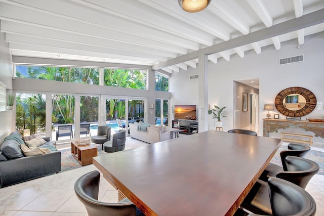 interior space featuring beam ceiling, french doors, and high vaulted ceiling